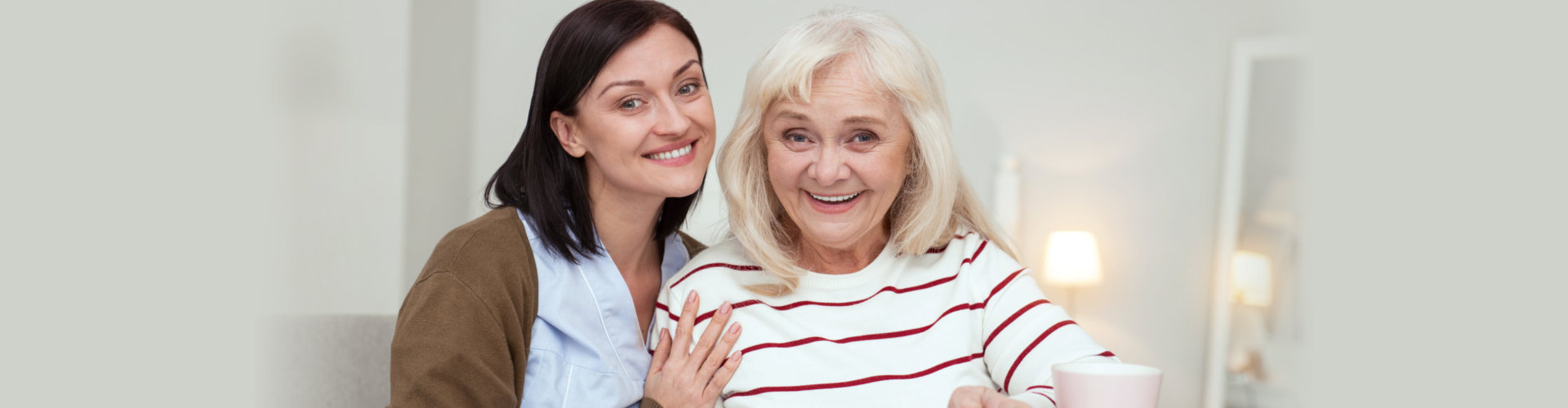 caregiver and old woman smiling